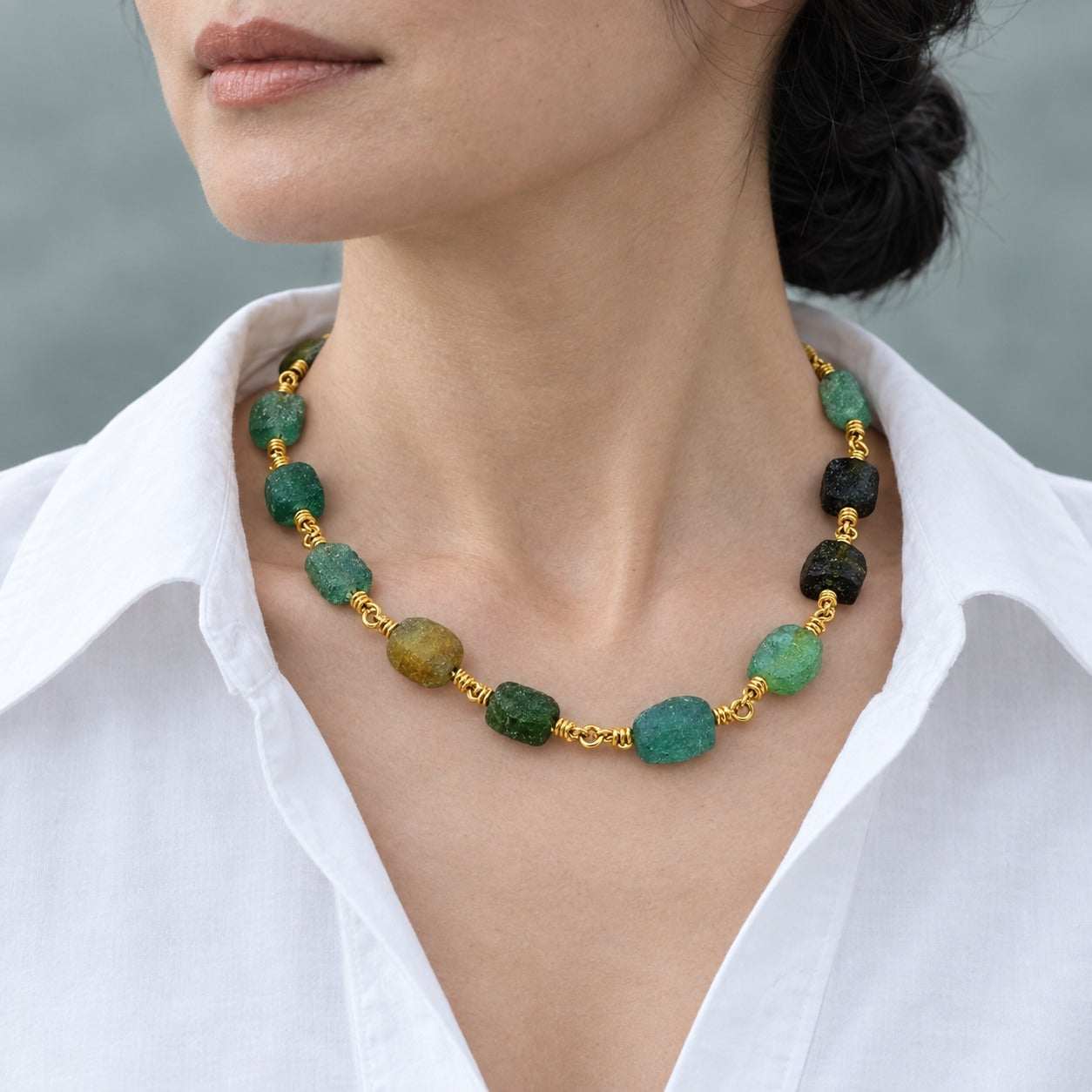 Model wearing the Lesunja Roman Glass Yellow Gold Necklace by Lesunja Fine Jewellery – AI-generated visualisation