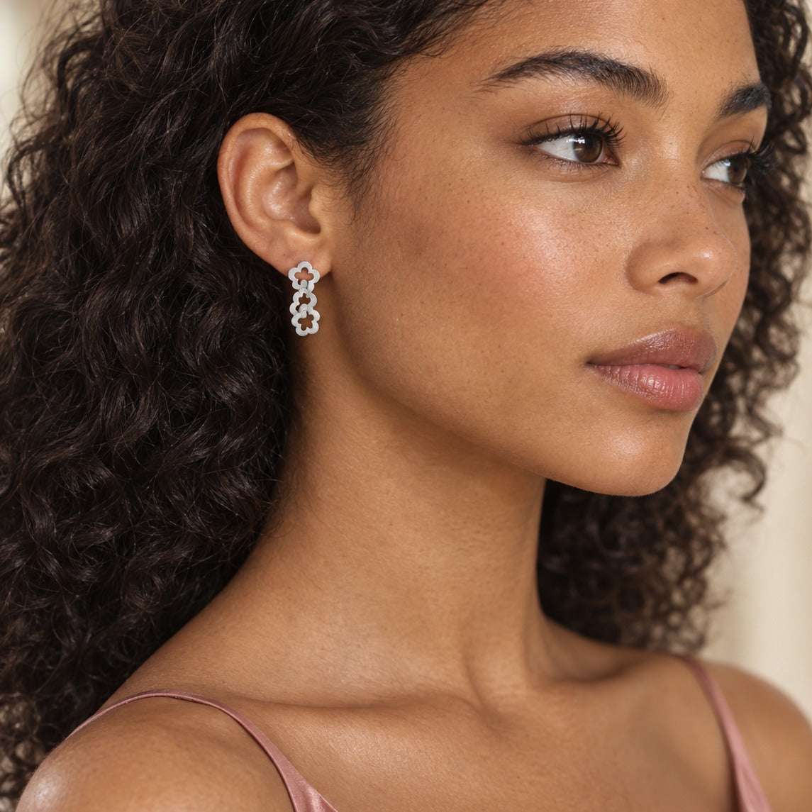 Model wearing the Lesunja Frosted Flower Silver Earrings by Lesunja Fine Jewellery – AI-generated visualisation