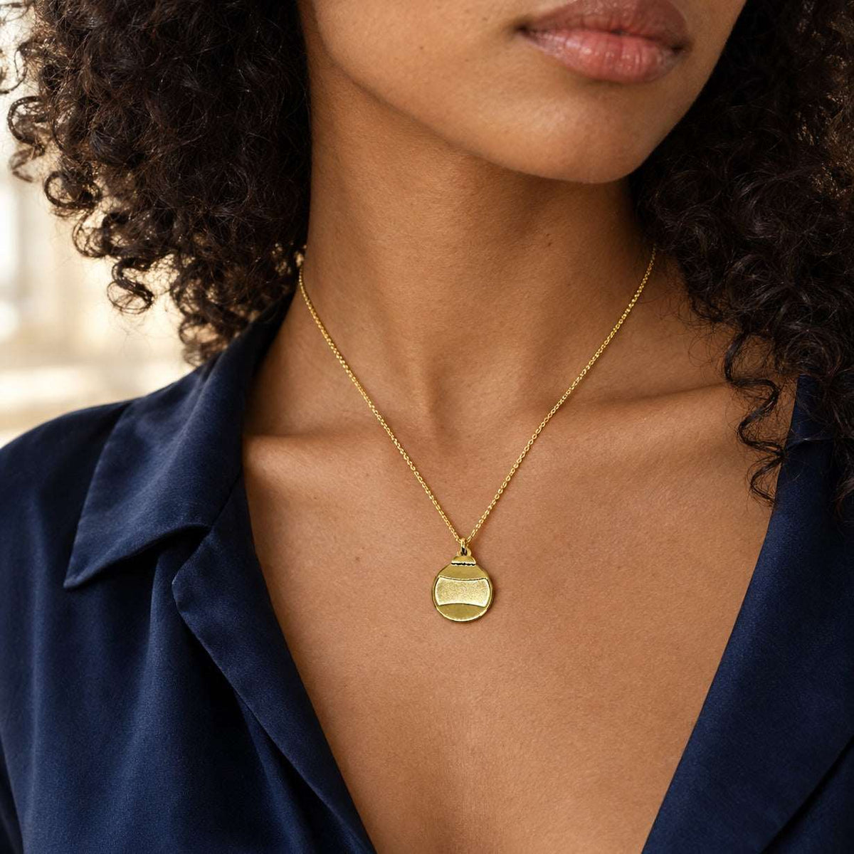 Model wearing the Lesunja Little Christmas Tree Ball Gold Plated Pendant Necklace by Lesunja Fine Jewellery – AI-generated visualisation