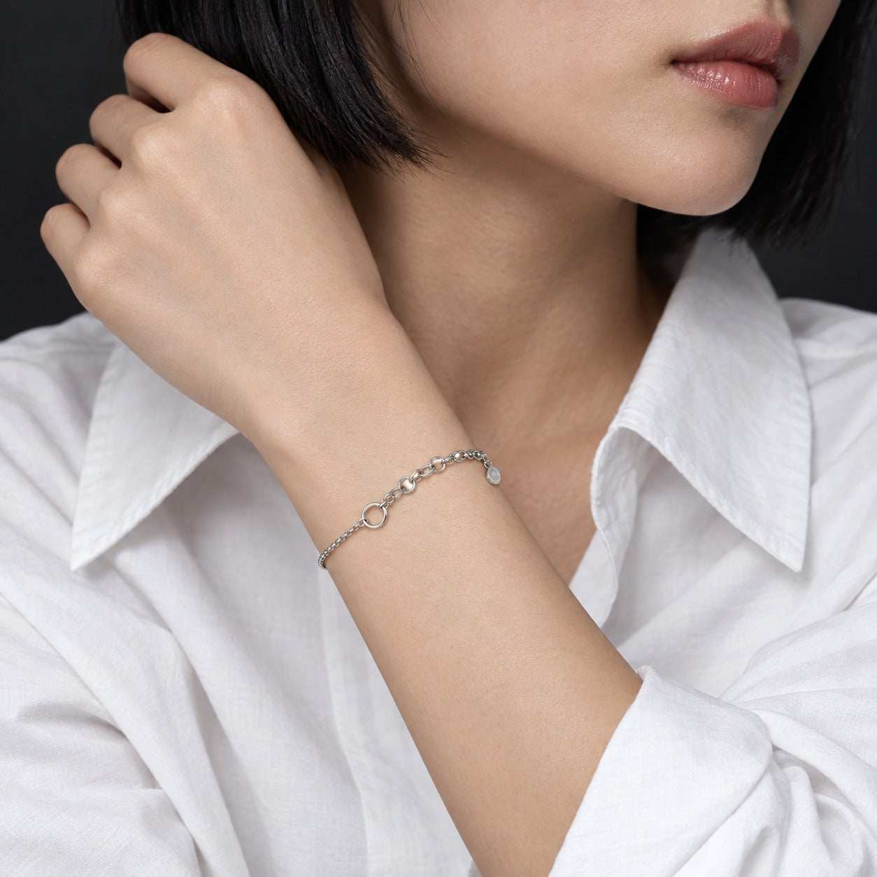 Model wearing the Lesunja Silver Charm Bracelet by Lesunja Fine Jewellery – AI-generated visualisation