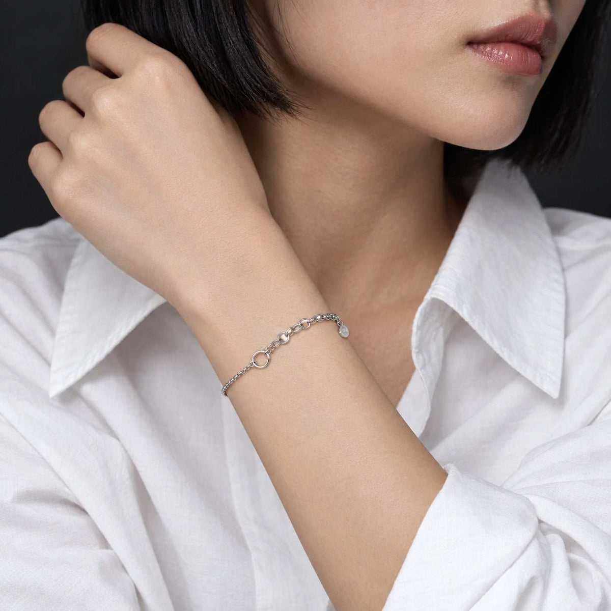 Model wearing the Lesunja Silver Charm Bracelet by Lesunja Fine Jewellery – AI-generated visualisation
