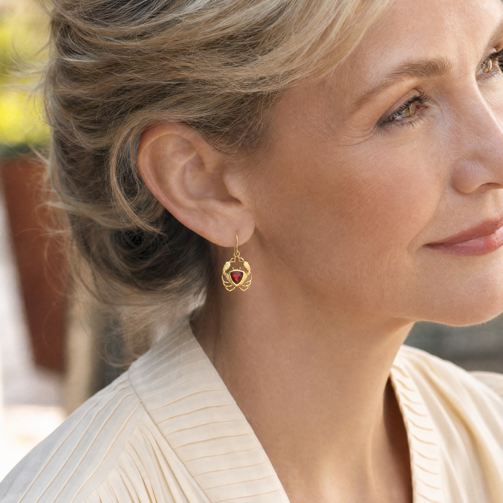 Model wearing the Lesunja Ocean XXY Cancer Ear Hangers Yellow Gold Fire Opal