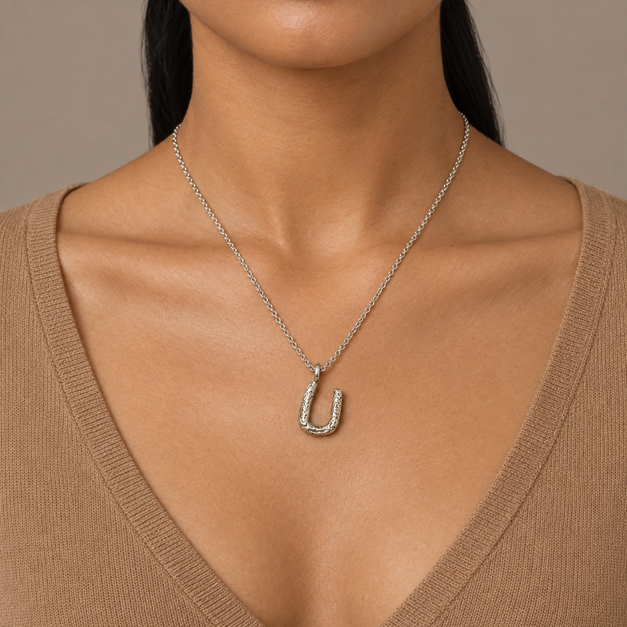 Model wearing the Lesunja Silver Letter U Necklace