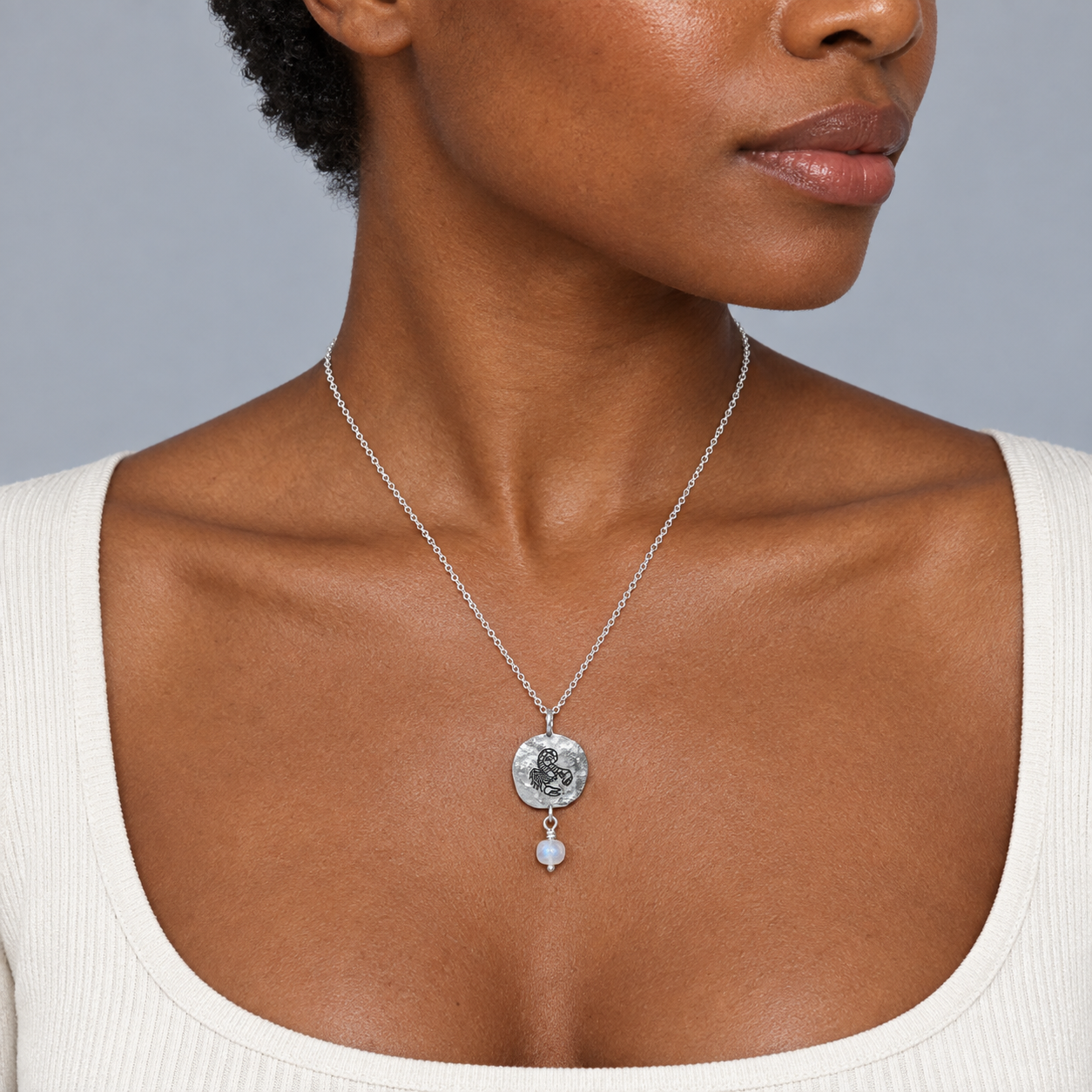Model wearing the Lesunja Zodiac Scorpio Silver Necklace Rainbow Moonstone