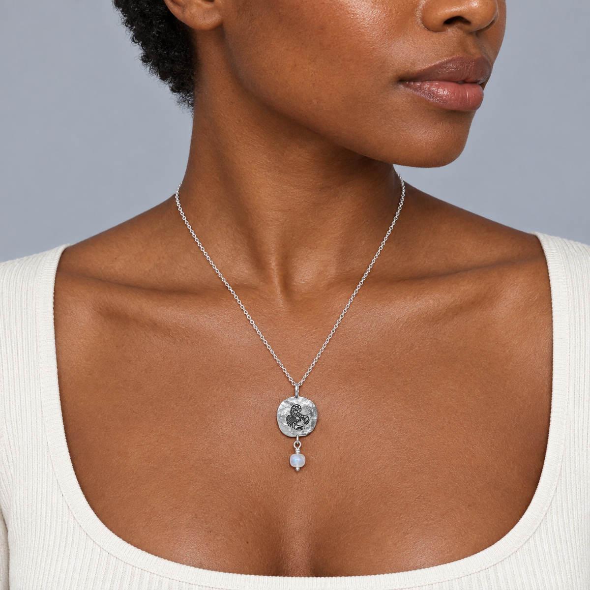 Model wearing the Lesunja Zodiac Scorpio Silver Necklace Rainbow Moonstone