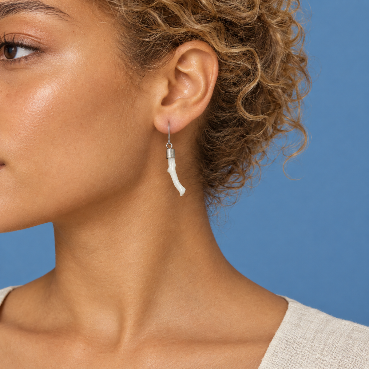 Model wearing the Lesunja Ear Hook Silver Coral
