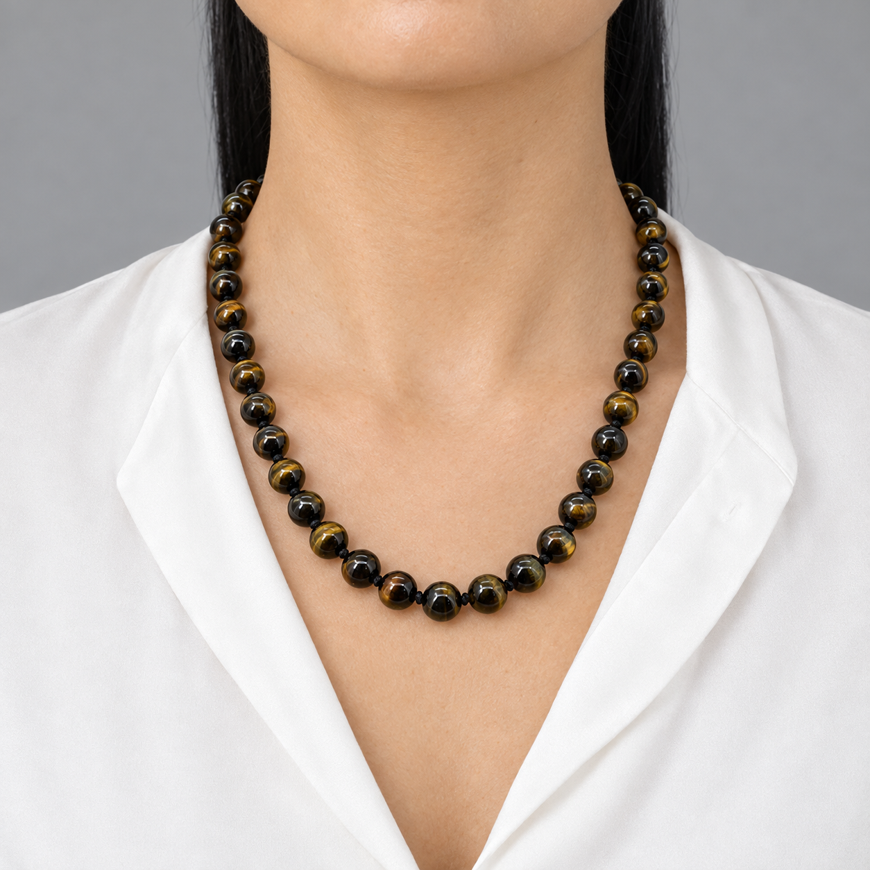 Model wearing the Lesunja Tiger Eyes Necklace