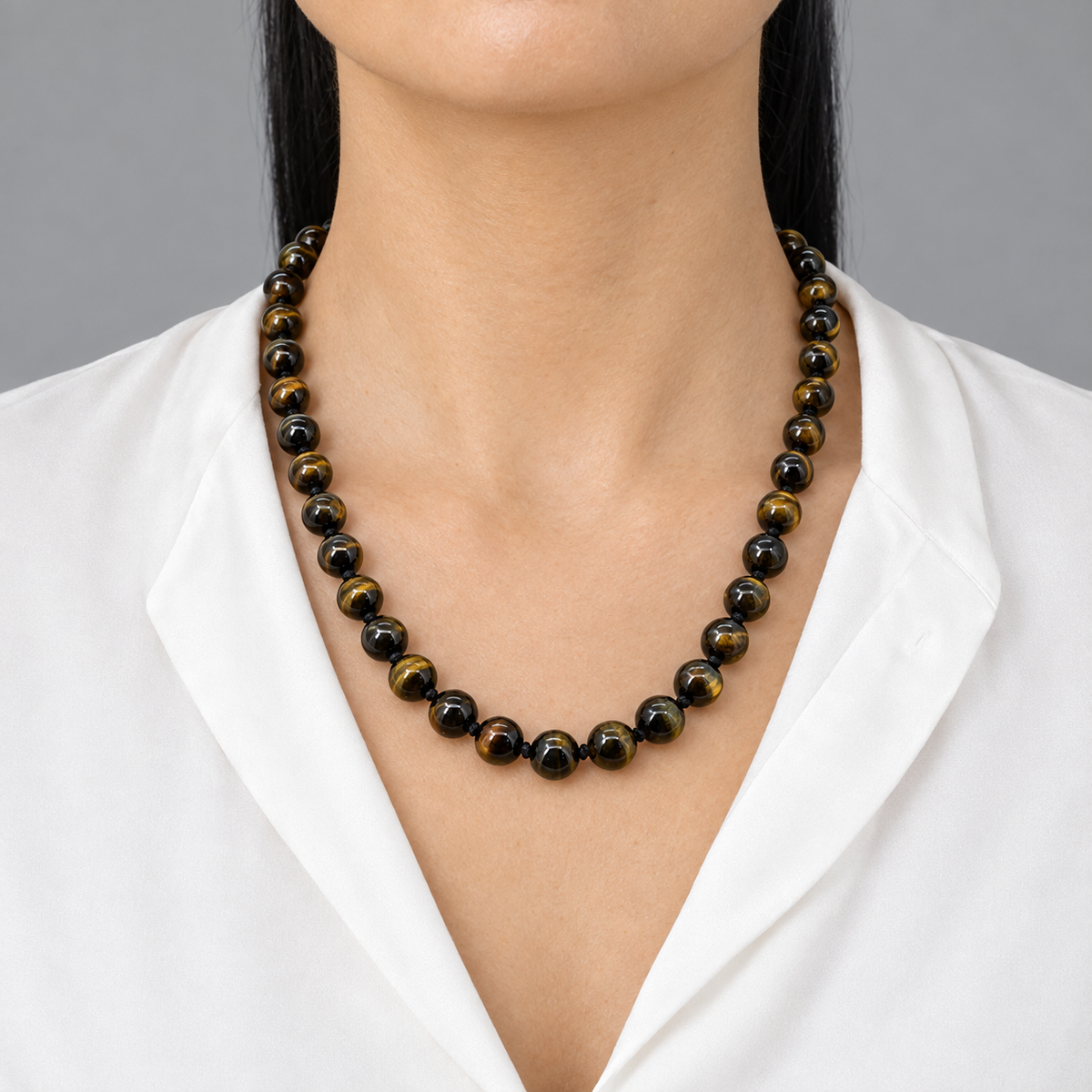 Model wearing the Lesunja Tiger Eyes Necklace