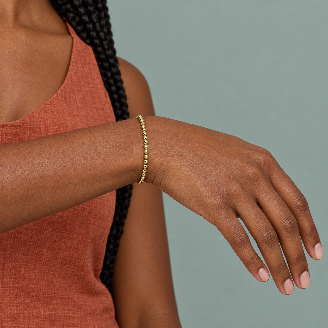 Model wearing the Lesunja Hematite Yellow Gold Plated Bracelet thin