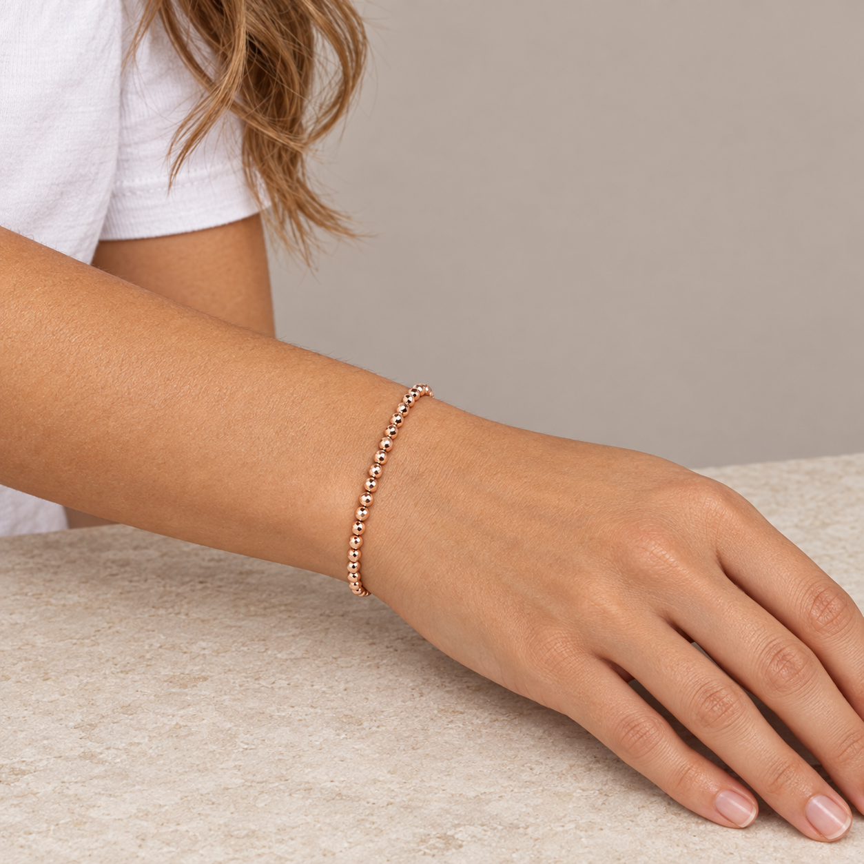 Model wearing the Lesunja Hematite Rose Gold Plated Bracelet 4.25mm Beads