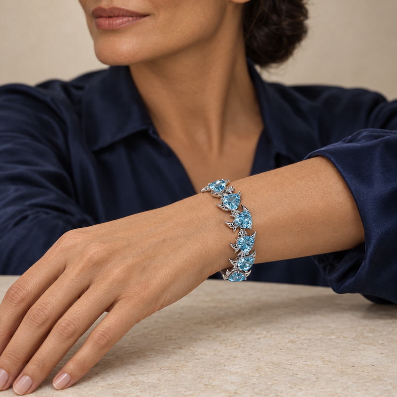 Model wearing the Lesunja Ocean XXY Fish Bracelet Platinum 950 Blue Topaz