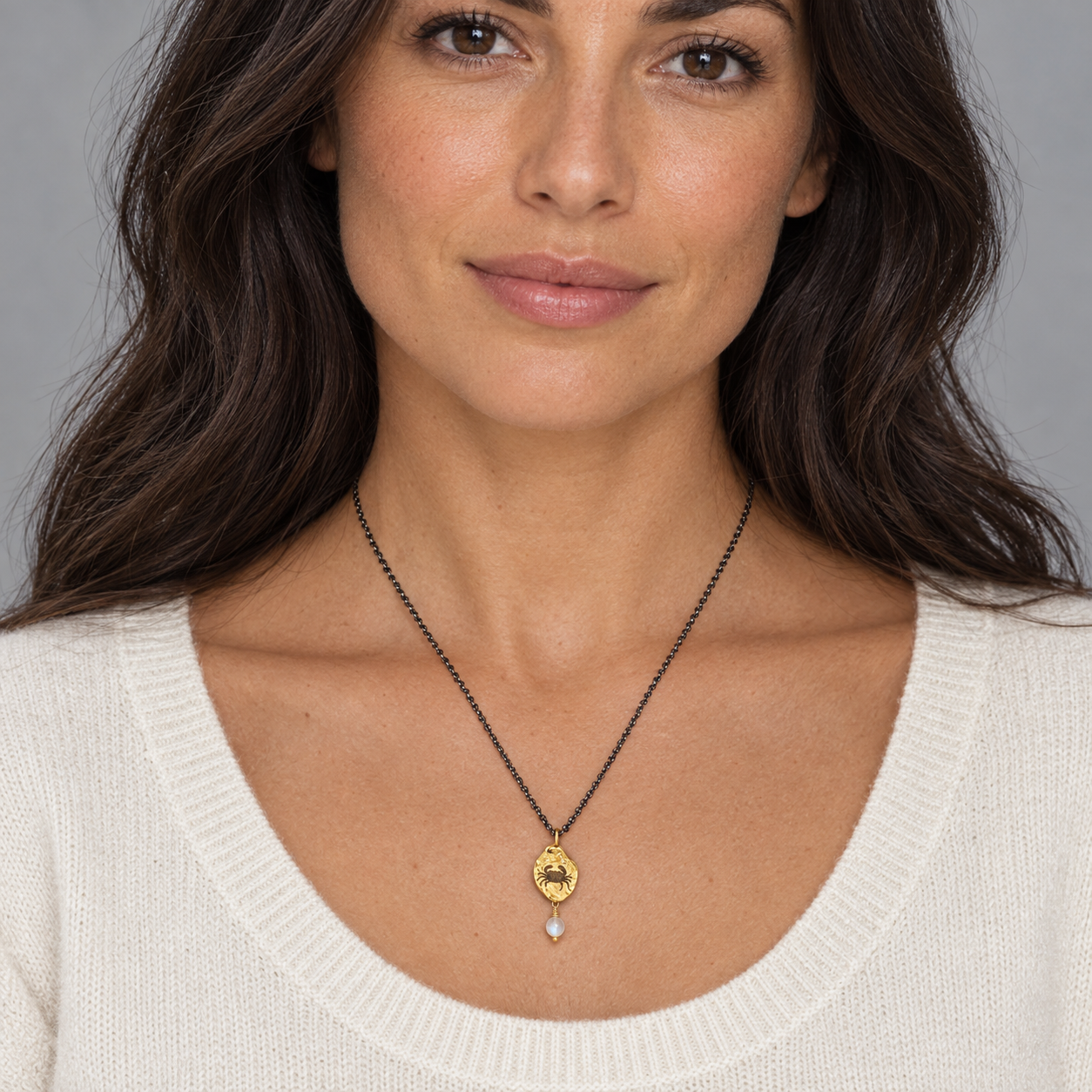 Model wearing the Lesunja Zodiac Cancer Silver Necklace Yellow Gold Nugget Moonstone
