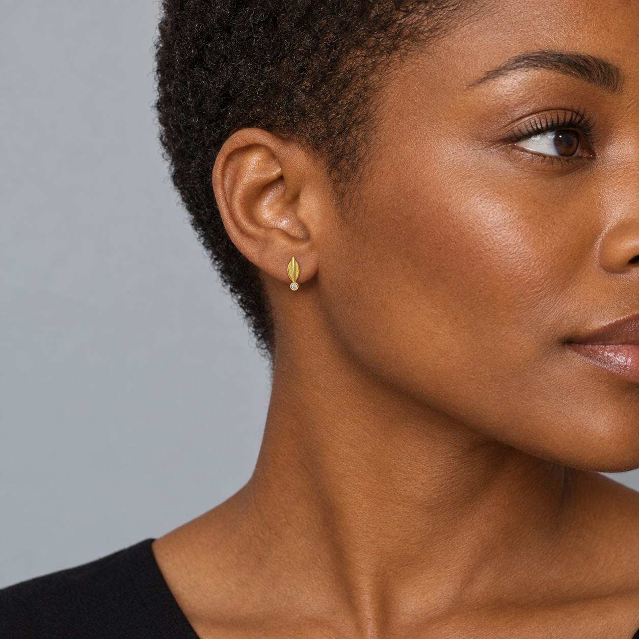 Model wearing the Lesunja Yellow Gold Leaf Earrings Studs