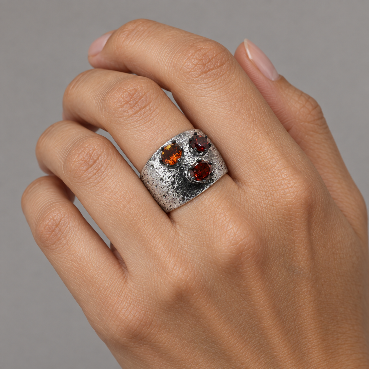 Model wearing the Lesunja Sea Urchin Silver Ring Orange & Red Garnet