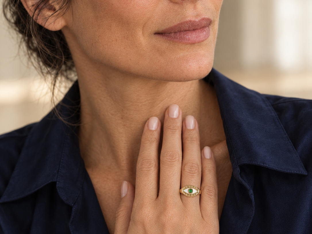 Model wearing the Lesunja Evil Eye Signet Ring Yellow Gold Green Garnet