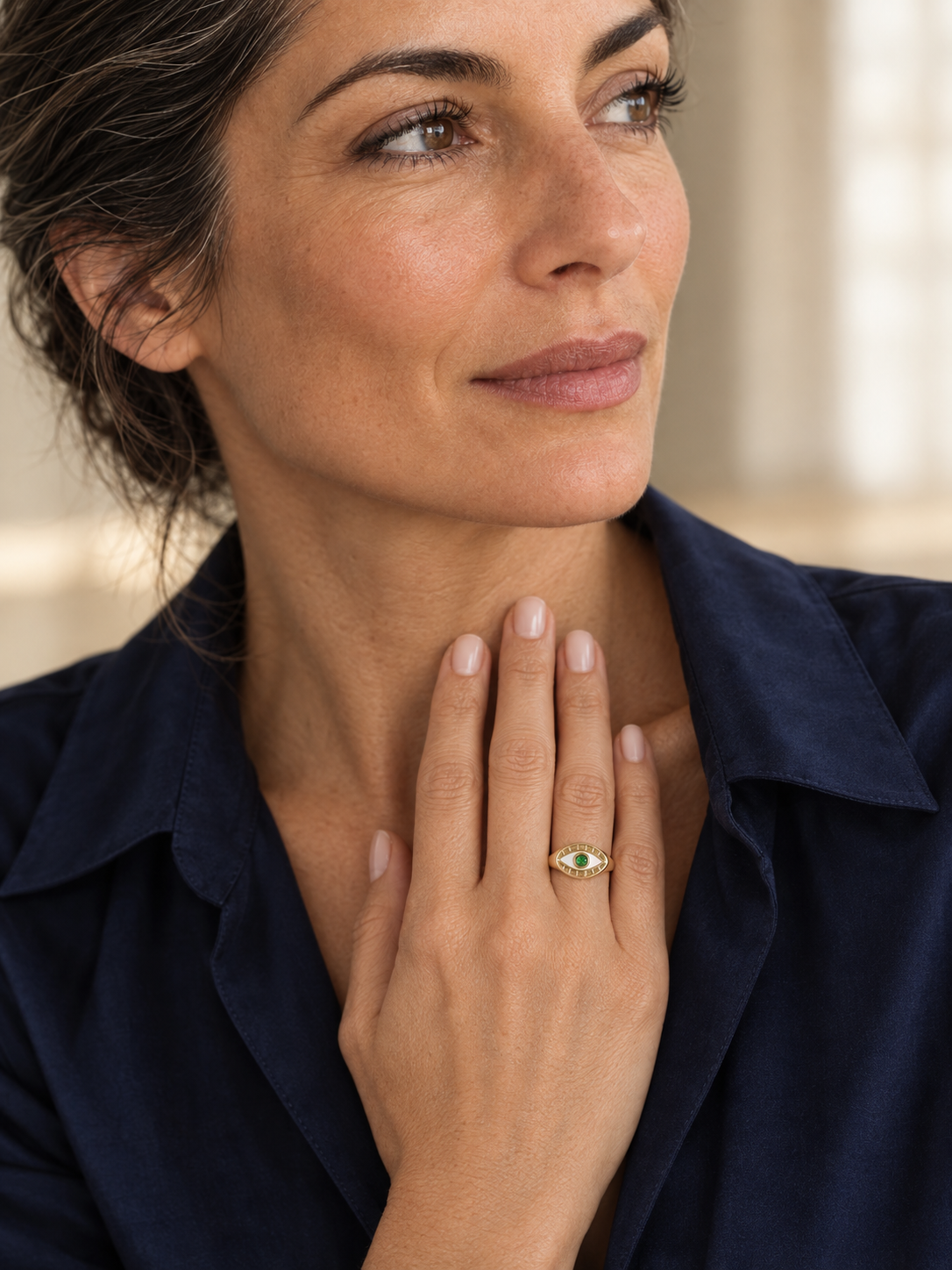 Model wearing the Lesunja Evil Eye Signet Ring Yellow Gold Green Garnet